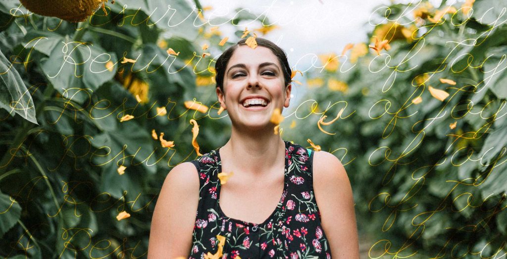 photo of woman laughing in a field of sunflowers