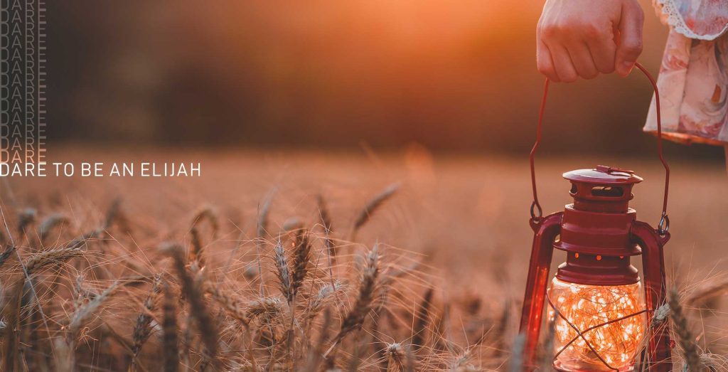 photo of woman holding a lantern in a field of ripe wheat. Text reads "Dare to be an Elijah."