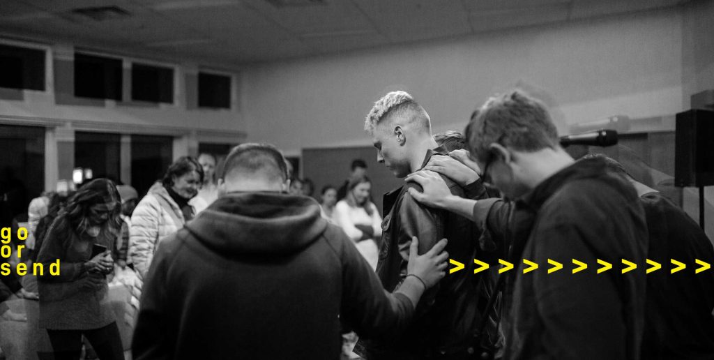 photo of people praying for someone to send them out in ministry